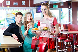 People in American diner or restaurant and waitress