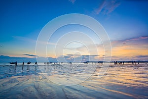 People on the Ao Nang beach at sunset in Krabi