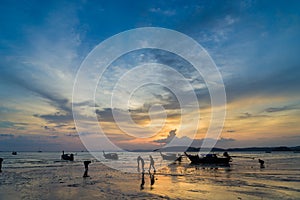 People on the Ao Nang beach at sunset in Krabi