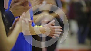 People applaud - close-up of clapping hands of standing people on dancing event