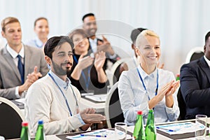 People applauding at business conference