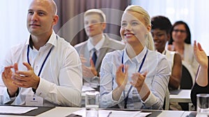 People applauding at business conference