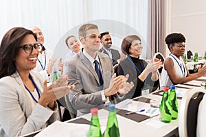 People applauding at business conference