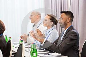 People applauding at business conference