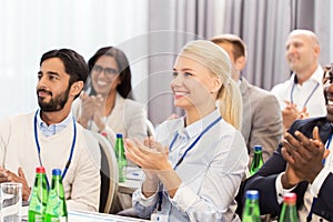 People applauding at business conference