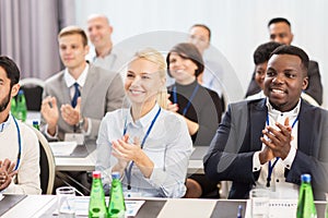 People applauding at business conference