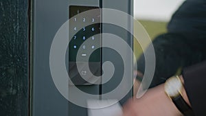 people applying a white plastic key card to an electronic Lock. Electronic door lock in the building of a large company.