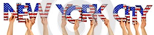 People arms hands holding up wooden letter lettering forming words new york city in USA american national flag colors tourism