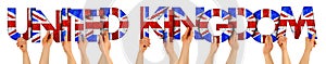 People arms hands holding up wooden letter lettering forming words united kingdom in union jack uk national flag colors tourism
