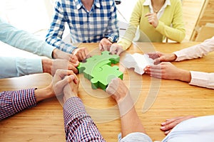 People assembling jigsaw puzzle