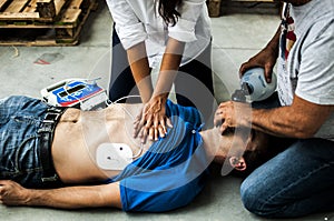 People assisting an unconscious man photo