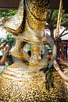 People attached gold leaf to the statue of Buddha