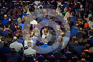 People attend business conference in congress hall