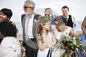 People attending a beach wedding ceremony