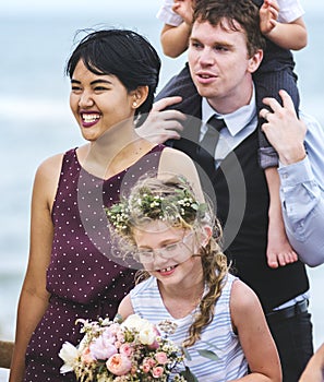 People attending a beach wedding ceremony