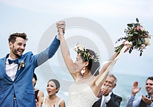 People attending a beach wedding ceremony