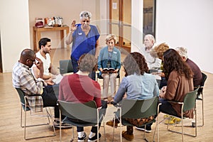 People Attending Bible Study Group Meeting In Community Center