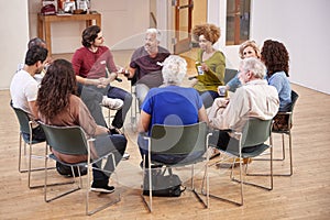 People Attending Self Help Therapy Group Meeting In Community Center