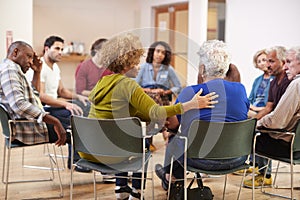 People Attending Self Help Therapy Group Meeting In Community Center