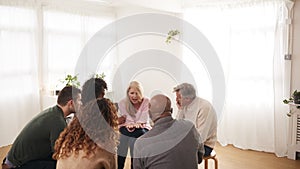 People Attending Support Group Meeting For Mental Health Or Dependency Issues In Community Space