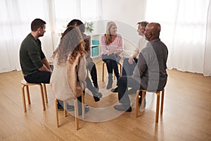 People Attending Support Group Meeting For Mental Health Or Dependency Issues In Community Space