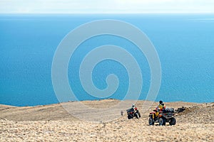 People on ATVs and motorcycles, go to the side of the reservoir lakes on the dry