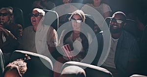 People, audience and cinema with 3d glasses for movie entertainment with popcorn, film festival or watching. Men, women