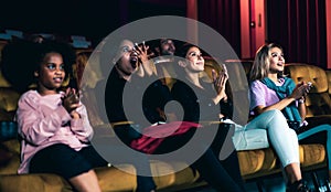 People audience watching movie in cinema theater.