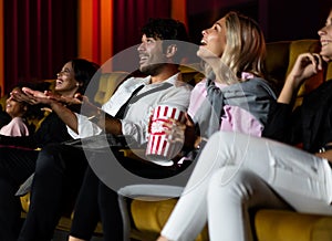 People audience watching movie in cinema theater.