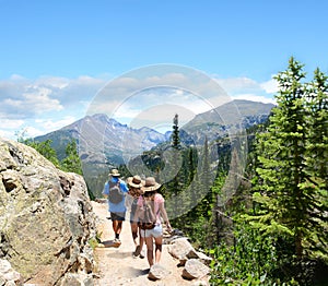 People with backpacks hiking on summer vacation.