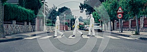 People in bacteriological protection suits walking down an empty street
