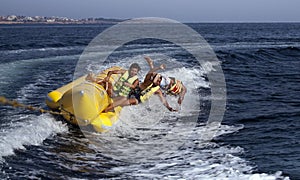 PEOPLE ON A BANANA BOAT