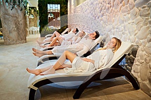 People in bathrobes are resting in the spa salon. photo