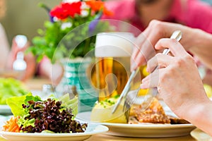 People in bavarian Tracht eating in restaurant or pub