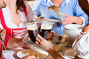 People in Bavarian Tracht eating in restaurant or pub