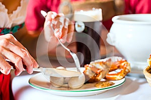 People in Bavarian Tracht eating in restaurant or pub photo