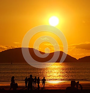 People on the beach golden sunset