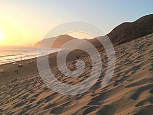 People on the beach at sunset in southern California