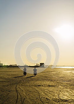 People on the beach at the sunset time