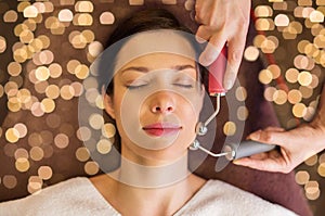 Woman having hydradermie facial treatment in spa photo