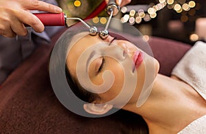 Woman having hydradermie facial treatment in spa photo