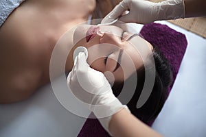 People, beauty, spa, healthy lifestyle and relaxation concept - close up of beautiful young woman lying with closed eyes and havin