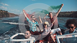 People on boat with colored smoke