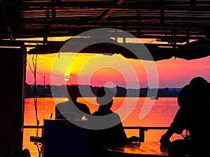 People on boat cruise wathcing the sunset on the Zambezi River