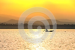People in boat with sunshine at lake