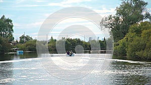 People Boating on a River in Autumn Evening