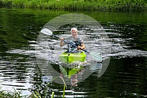 People boating on river in summer day.