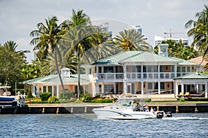 People boating tour by mansions in Fort Lauderdale FL USA