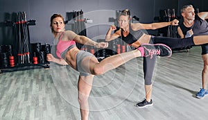 People in a boxing class training high kick