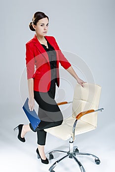 People in Business. Full Length Portrait of Tranquil Female Enterpreneur Posing in Red Blazer And Notepad  Against White